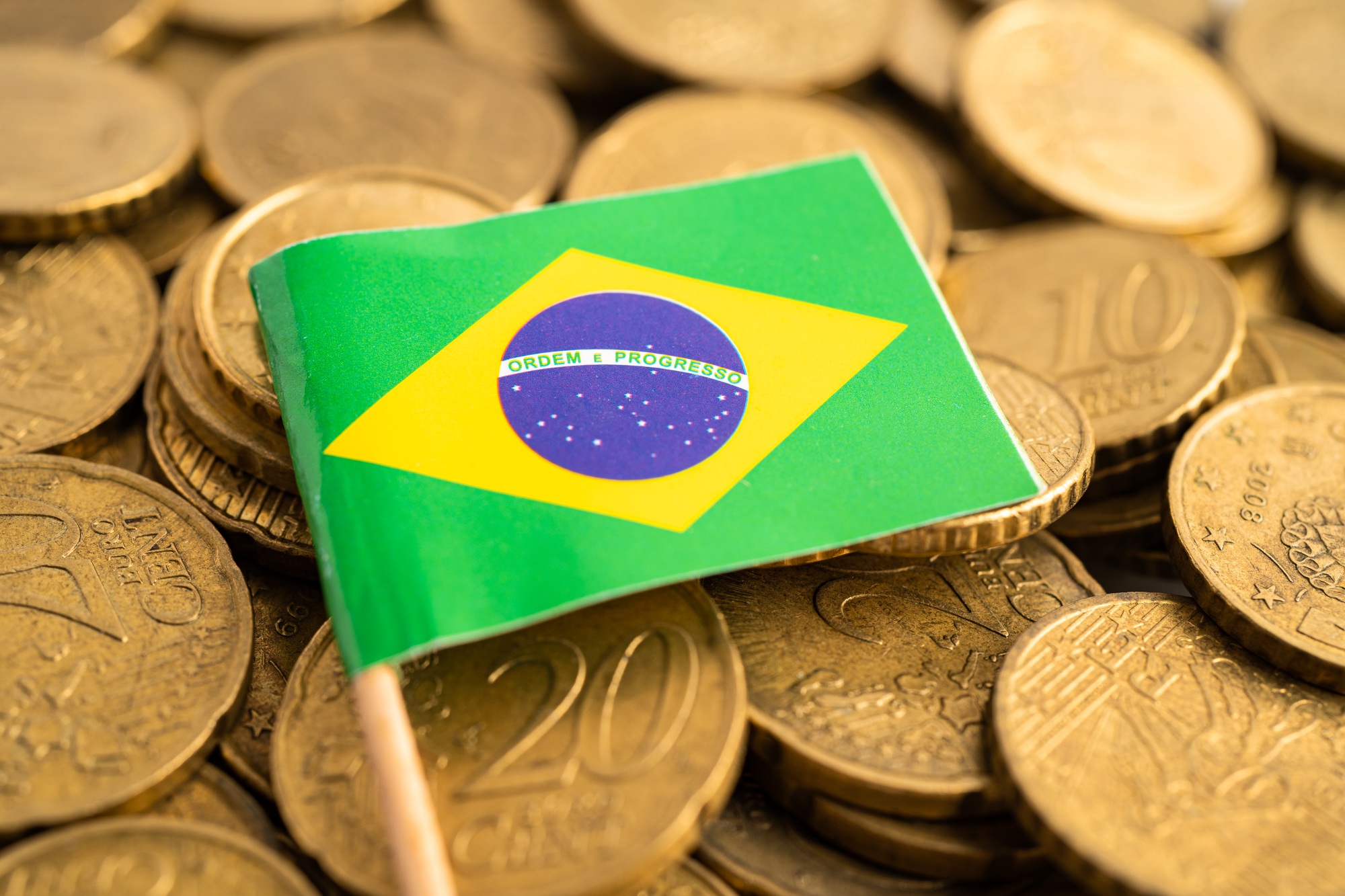 Brazil flag on coins money, finance and accounting, banking concept.